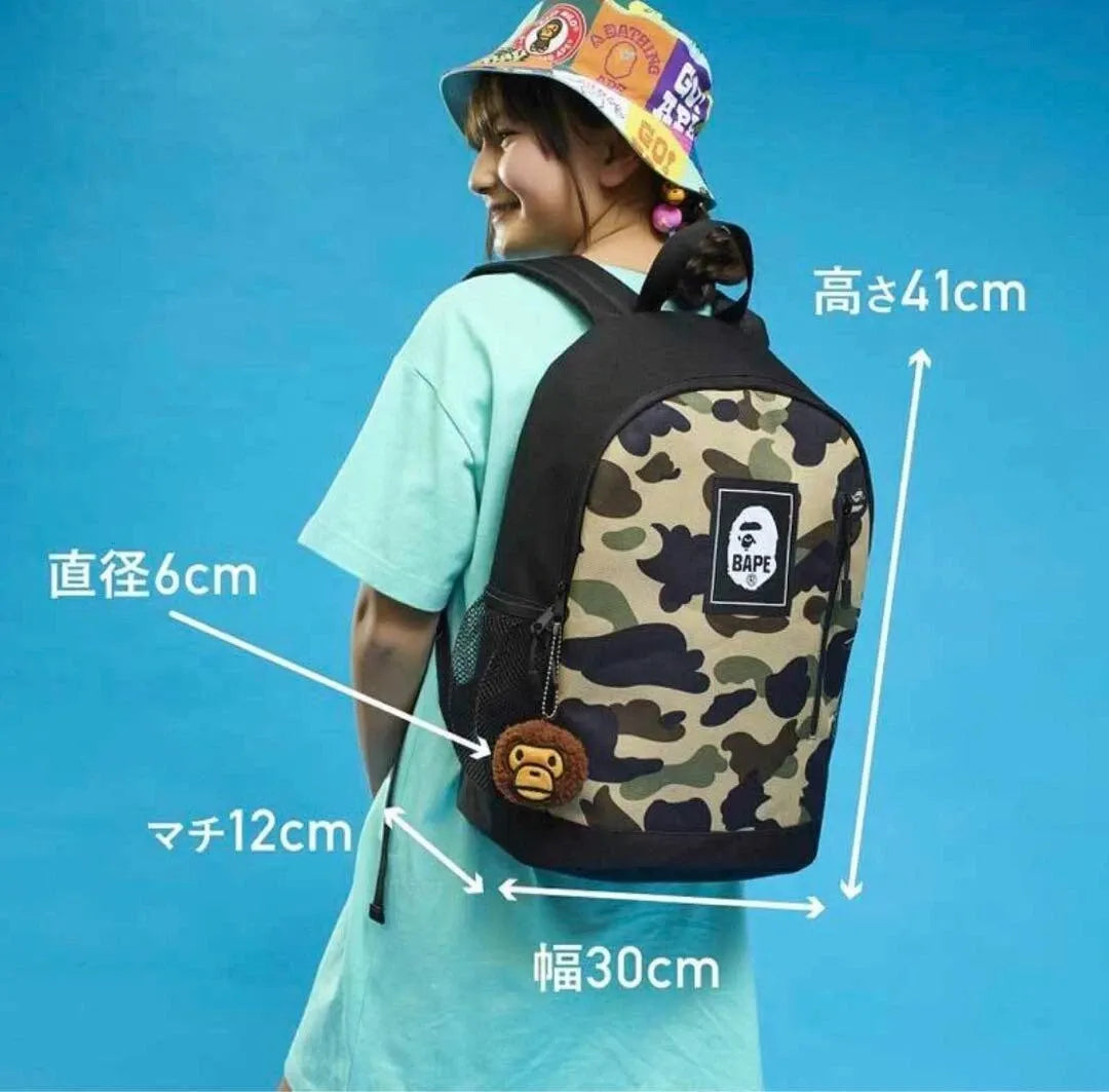 BAPE KIDS® BY A BATHING APE® 2022 SPRING/SUMMER COLLECTION CAMO BACKPACK & MILO CHARM BOOK